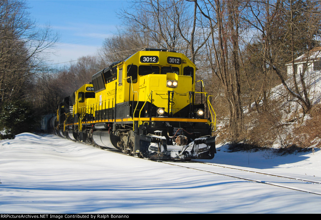 SU-99-22 grinds  uphill through town on an overcast monday eveing with a borrowed CSXT SD40-2 leading